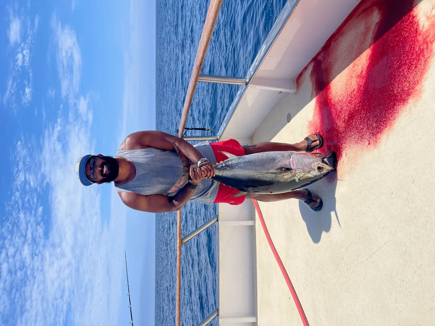 Nikhil holding a tuna on deck